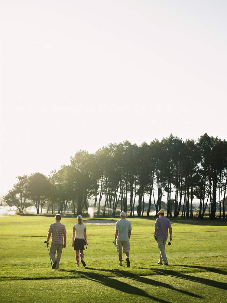 people-walking-across-golf-course